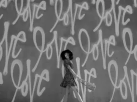 Person in from of wall with graffiti